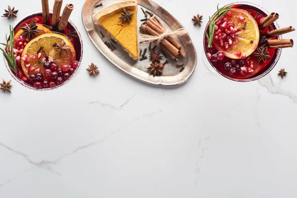 Top view of christmas cocktails with orange, pomegranate, cinnamon and pie on tray — Stock Photo