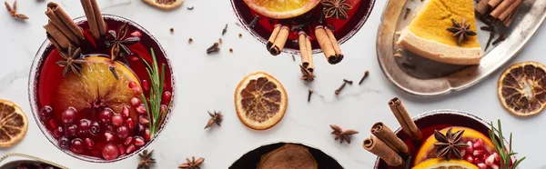 Panoramic shot of christmas cocktails with orange, pomegranate, cinnamon, pie on tray — Stock Photo