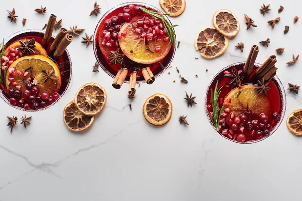 Top view of christmas cocktails with orange, pomegranate, cinnamon — Stock Photo