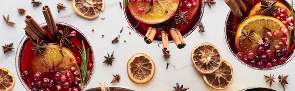 Panoramic shot of christmas cocktails with orange, pomegranate, cinnamon — Stock Photo