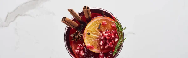 Panoramic shot of christmas cocktail with orange, pomegranate, cinnamon — Stock Photo