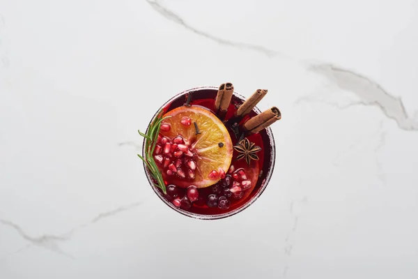 Top view of christmas cocktail with orange, pomegranate, cinnamon — Stock Photo