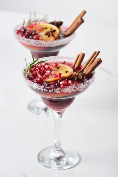 Selective focus of christmas cocktail with orange, pomegranate, cinnamon — Stock Photo