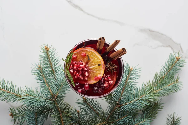 Top view of christmas cocktail with orange, pomegranate, cinnamon — Stock Photo