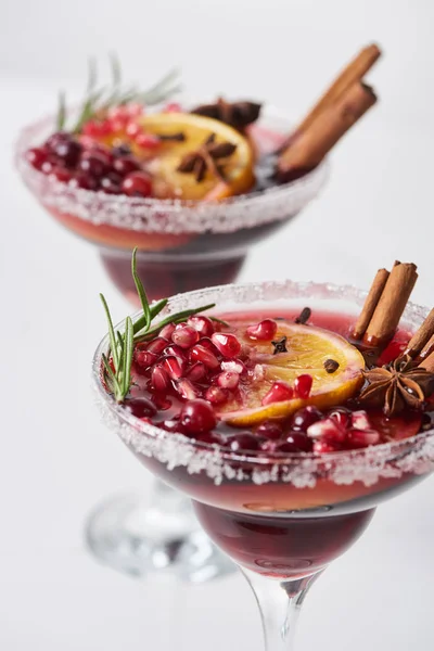 Selective focus of christmas cocktail with orange, pomegranate, cinnamon — Stock Photo