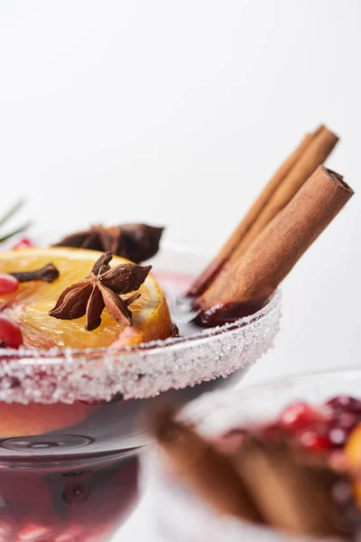 Selective focus of christmas cocktail with orange, pomegranate, cinnamon — Stock Photo