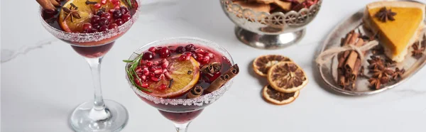 Panoramic shot of christmas cocktail with orange, pomegranate, cinnamon and apple pie — Stock Photo