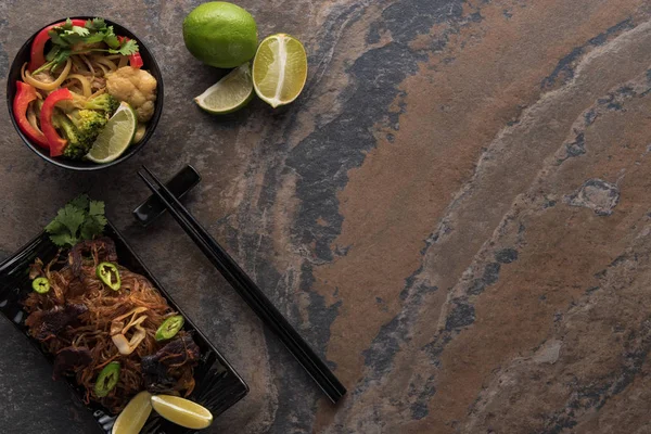 Top view of fresh spicy thai noodles with chopsticks on stone surface — Stock Photo