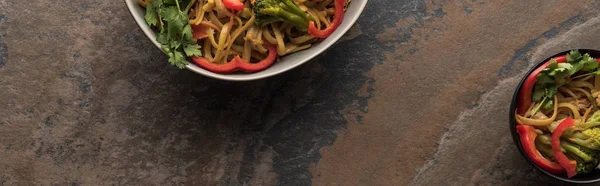 Top view of thai noodles near chopsticks on stone surface, panoramic shot — Stock Photo