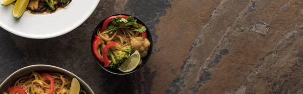 Top view of thai noodles with vegetables near chopsticks, panoramic shot — Stock Photo