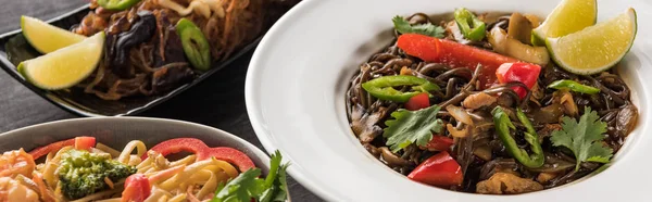 Close up view of thai noodles on wooden grey surface, panoramic shot — Stock Photo