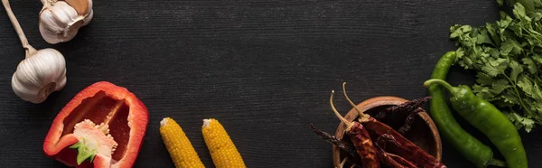 Top view of garlic, parsley, corn, bell pepper, jalapenos on wooden grey surface, panoramic shot — Stock Photo