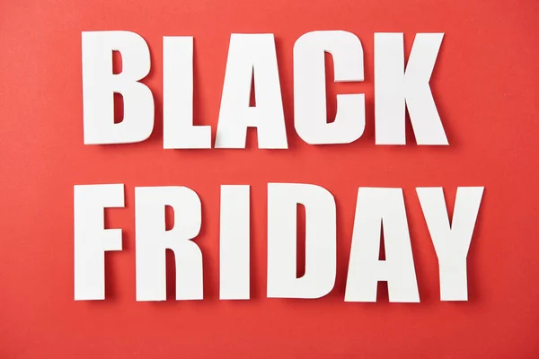 Top view of black friday white lettering on red background — Stock Photo