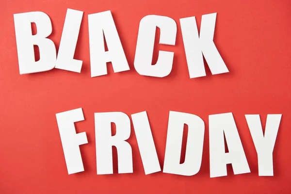 Top view of black friday white lettering on red background — Stock Photo