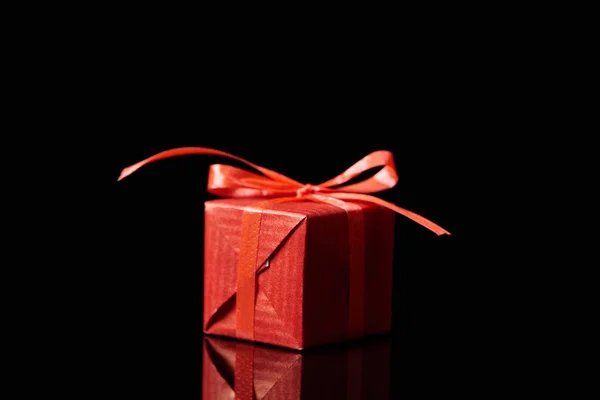 Red decorative gift isolated on black with copy space — Stock Photo