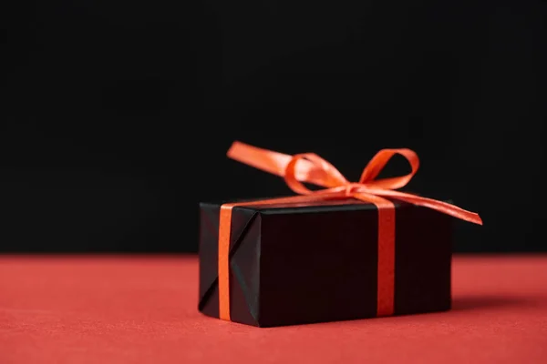 Presents with red ribbon and bow isolated on black — Stock Photo