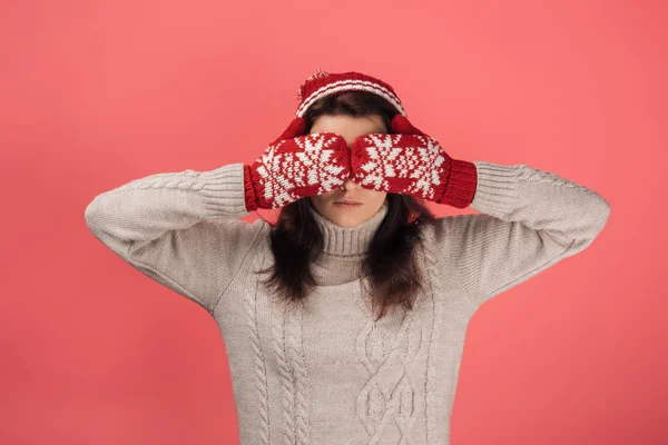 Donna in guanti rossi e cappello lavorato a maglia che copre gli occhi di rosa — Foto stock