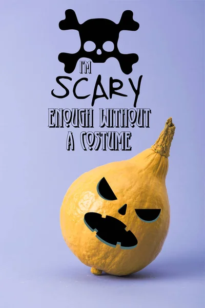 Yellow colorful painted pumpkin on violet background with i am scary enough without a costume illustration — Stock Photo