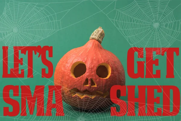 Spooky Halloween pumpkin on green background with lets get smashed illustration — Stock Photo