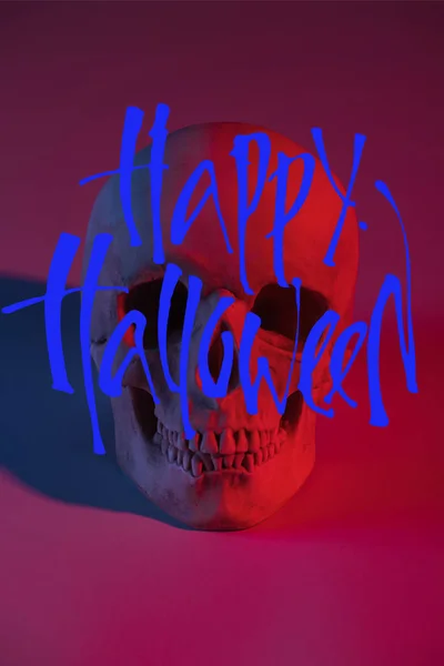 Spooky human skull in red lighting, Halloween decoration with Happy Halloween illustration — Stock Photo