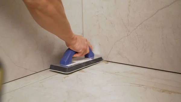 Grouting the floor with tiles. Grouting ceramic tiles.