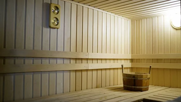 The interior of the sauna. Sauna from linden.. Sauna accessories are in the interior of the steam room