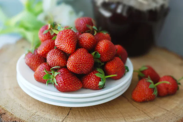 Strawberry Jam and Fresh Strawberries Textured Cement Grauy Background