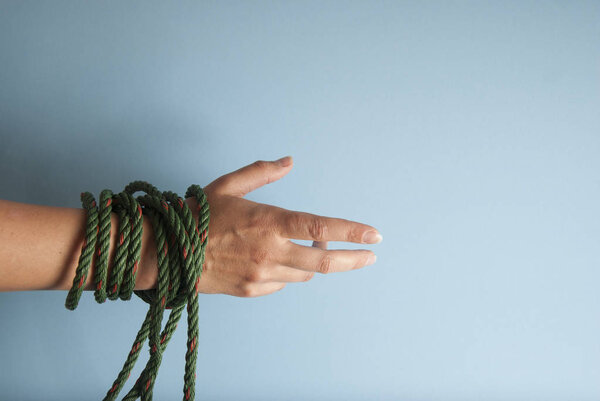 Tied Women Hands Freedom Concept isolated Blue Board