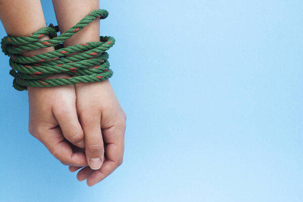 Tied Women Hands, Violence, Freedom Concept Isolated blue background