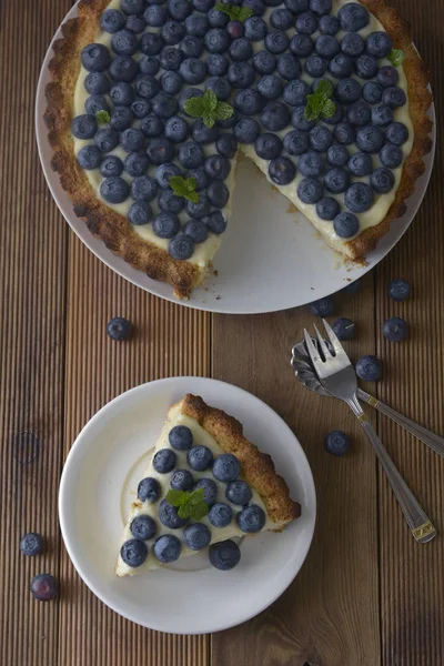 Blueberry Tart. Homemade piece of berry tart, cake with cream. Fresh sweet dessert with fruit.