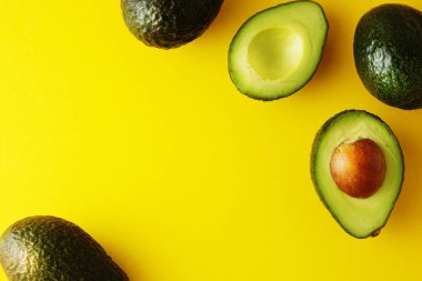 Sarı arka plan üzerinde izole olgun taze avokado. Renkli sağlıklı gıda arka plan. Avokado izole. Kopya alanı.
