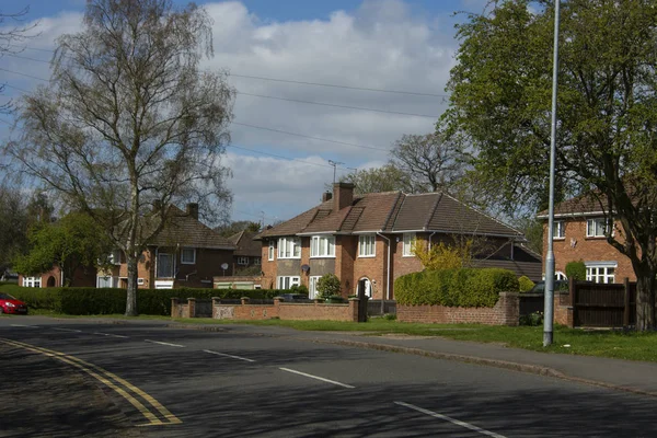 Traditional, tipycal english house. Brick stone house. street view. Spring time.