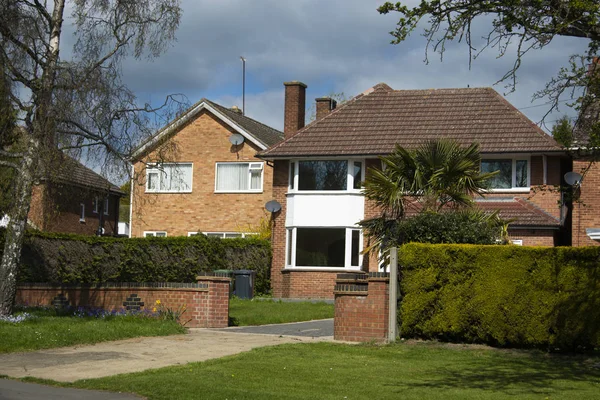 Traditional, tipycal english house. Brick stone house. street view. Spring time.