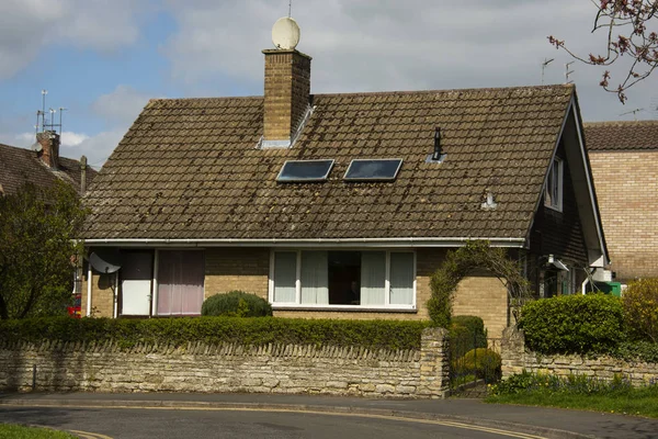 Traditional, tipycal english house. Brick stone house. street view. Spring time.