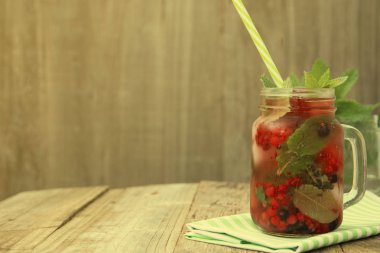 Şık taze buz, soğuk meyve çay arka plan, saman ile Mason kavanoz fincan, yaz meyve çay içeceği, ahşap arka plan. Kopyalama alanı.