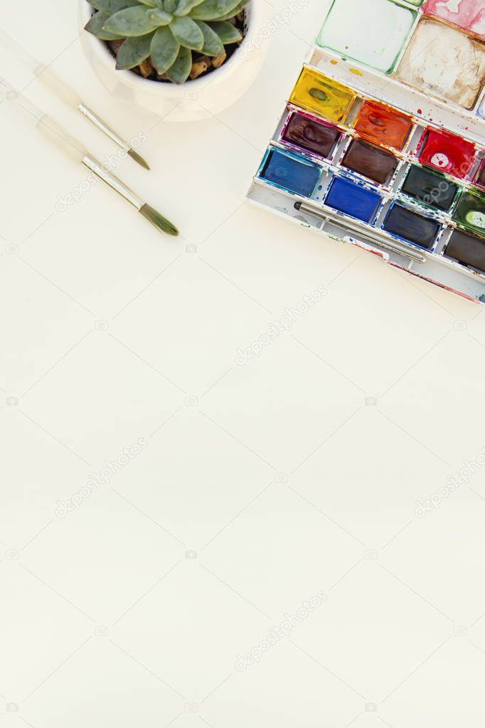 Set of watercolor paints isolated for painting closeup. Selective focus. Art, creative background with copy space.