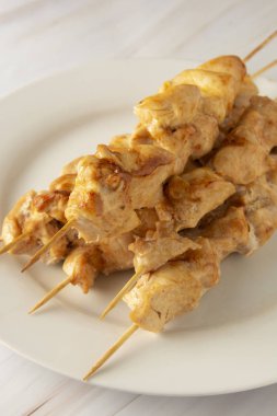 Bambu şiş kebap beyaz tabakta tavuk eti, mermer parlak arka plan. Diyet az yağlı gıda.