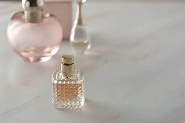 Beauty products. Perfume or parfume bottle on marble background. Copy space.