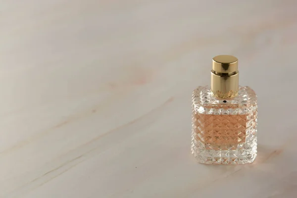 Beauty products. Perfume or parfume bottle on marble background. Copy space.