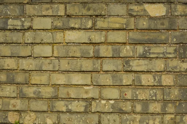 Stary, żółty prawdziwy kamień ceglany mur, tło ceglane ściany. — Zdjęcie stockowe