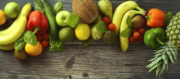 Fruti and vegetables background. Different fruits and vegetables over wooden background. Banner. Copy space.