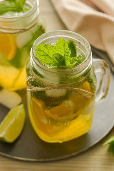 Homemade lemonade with lime, mint in a mason jar on a wooden rustic table. Summer drinks. — Stock Photo, Image