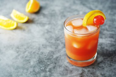 Yaz kokteyli. Nane, syrop, meyve dilimleri ve buz ile kiraz ile Portakal suyu. Koyu arka plan.