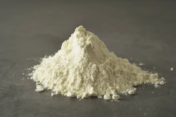 Pile or heap of rice flour isolated ondark background. Gluten free flour. Healthy food. — Stock Photo, Image
