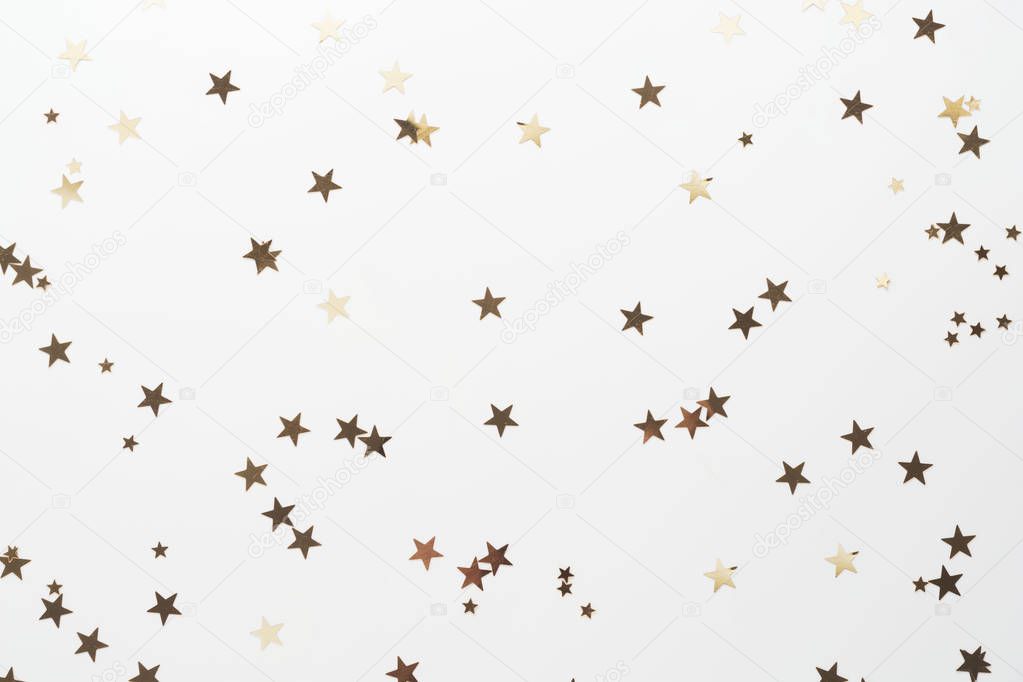 Golden glitter, confetti stars isolated on white background. Christmas, party or birthdau background.