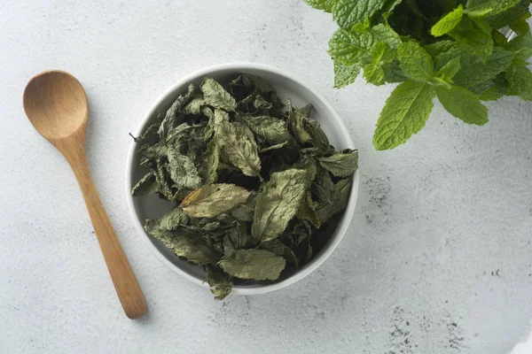 Mint Tea. Dry mint leaves in bow, over light background, isolated.