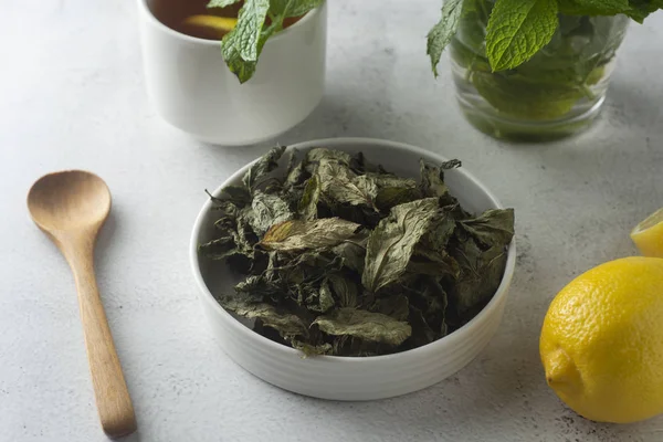 Mint Tea. Dry mint leaves in bow, over light background, isolated.