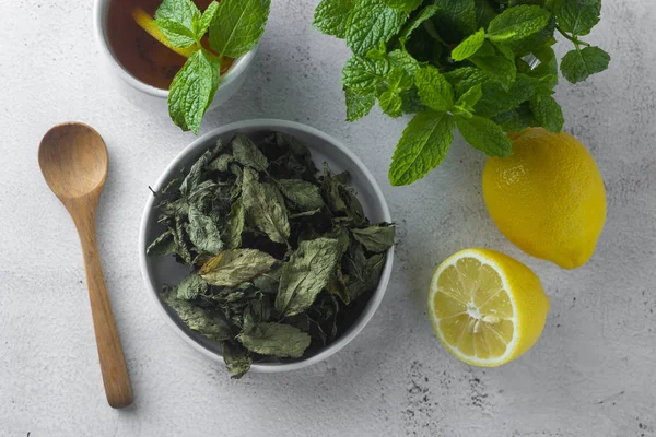 Mint Tea. Dry mint leaves in bow, over light background, isolated.