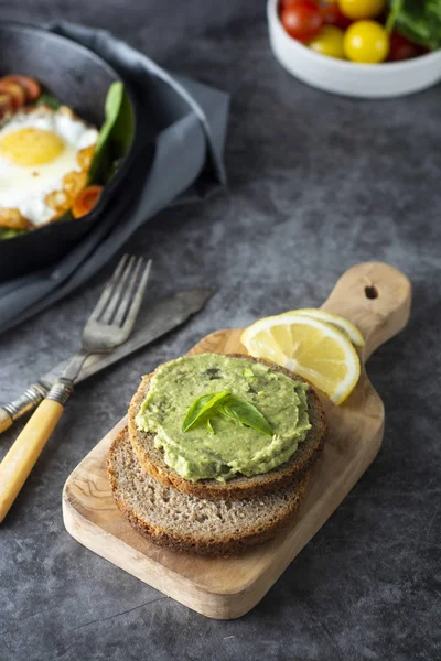 Appetizing guacamole, avocado pasta sandwich. Mexican guacamole. Delicious green snack from avocado.