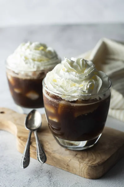 Affogato coffee with ice cream on a glass cup, grey background.